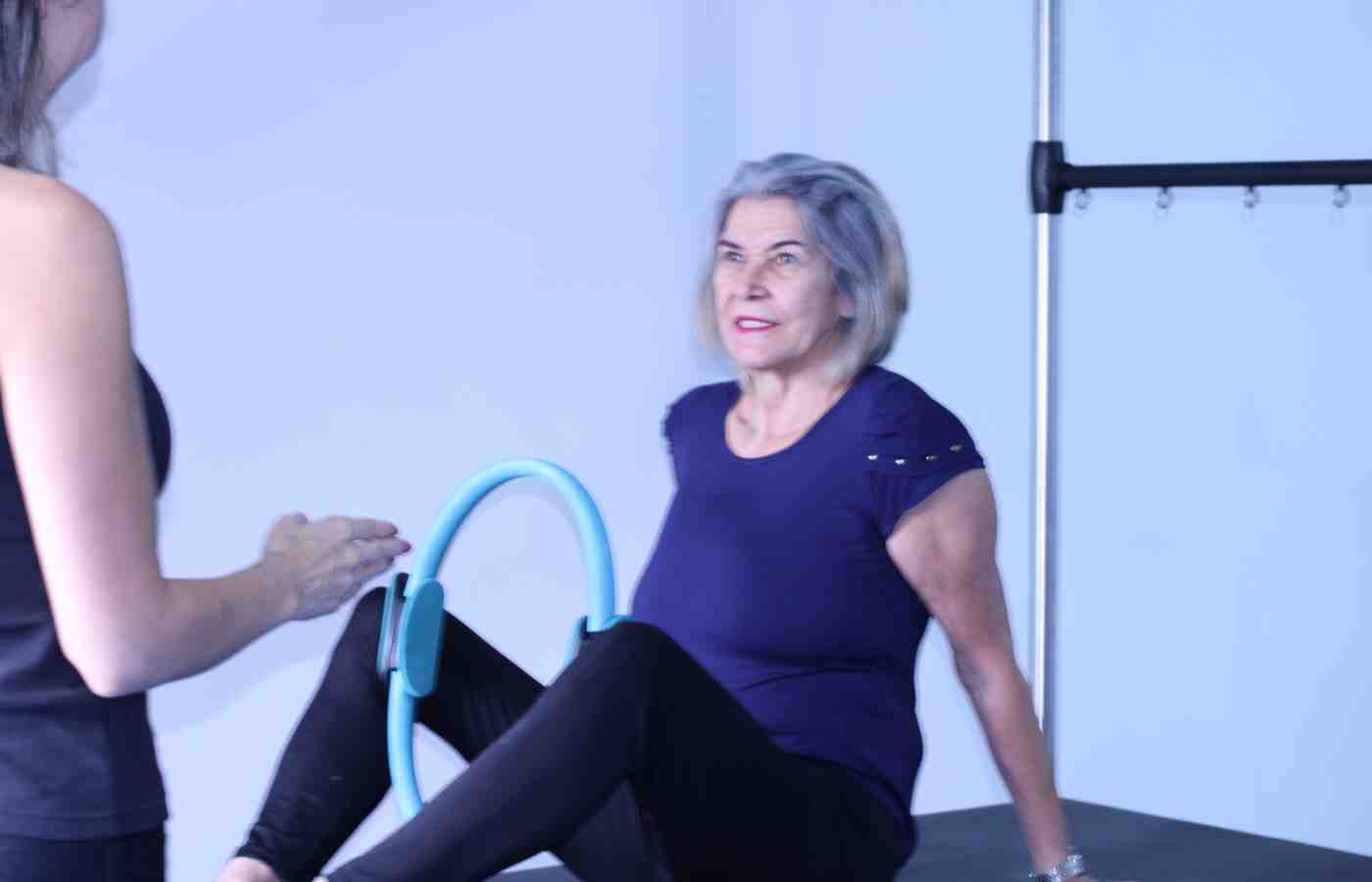 Client performing standing strength and balance work in a Pilates studio