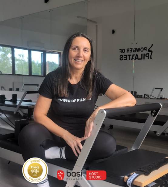 Claire in the reformer studio at Power of Pilates